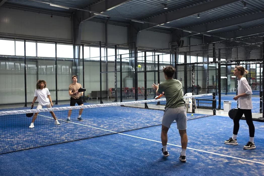 people playing
paddle tennis inside