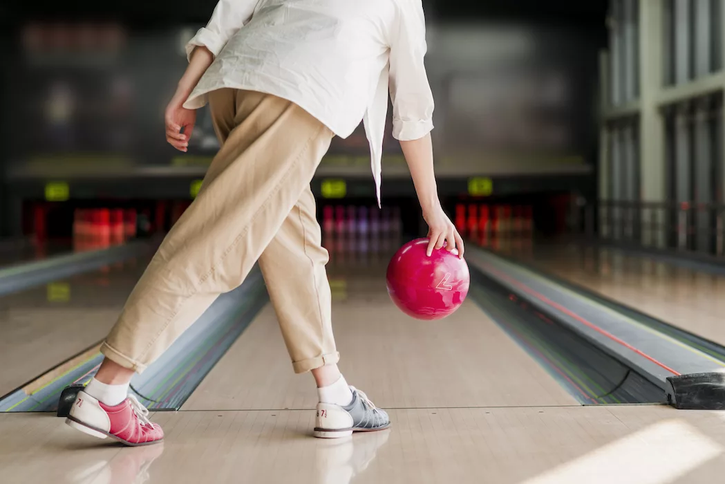 person throwing a bowling ball